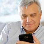 Portrait of senior man using smartphone