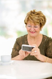 elderly woman reading emails on smart phone