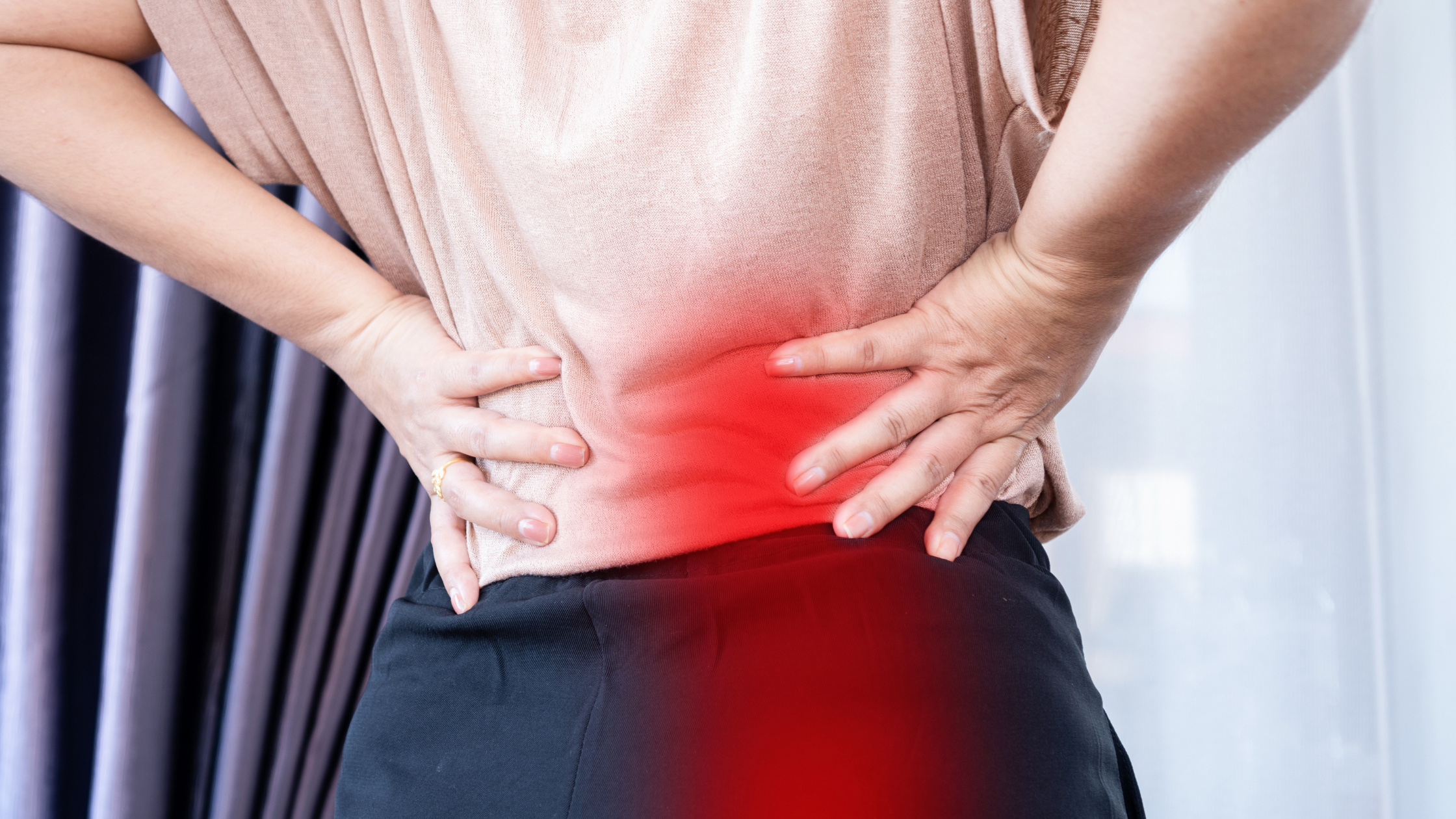 Person holding lower back and hip from sciatica pain