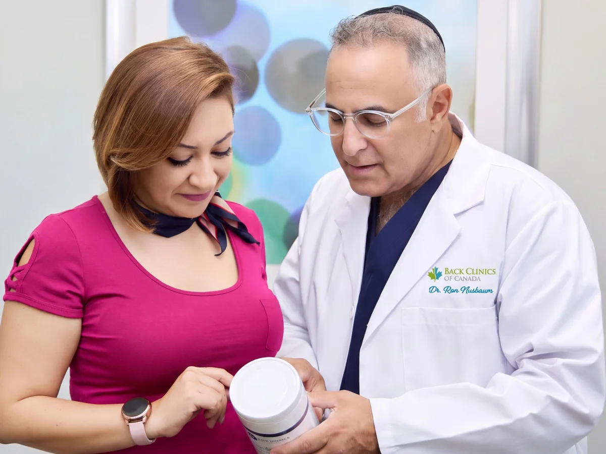 Dr. Ron Nusbaum showing a patient Disc Renewal Plus nutritional support